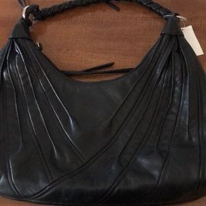 Pretty black pocketbook fringe on one side one inside zipper compartment.